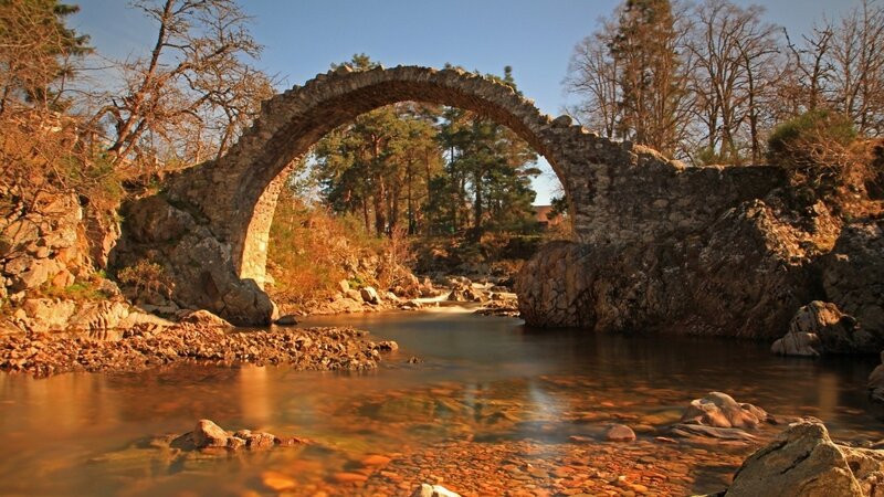 Stone arch bridge over river