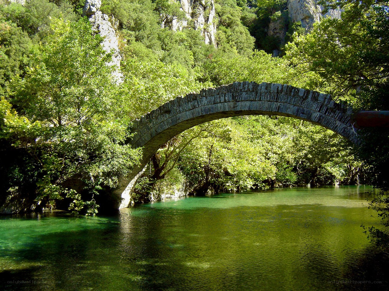 Stone arch bridge over river