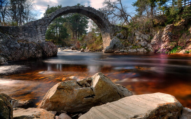 Stone Arch Bridge over River — Brown