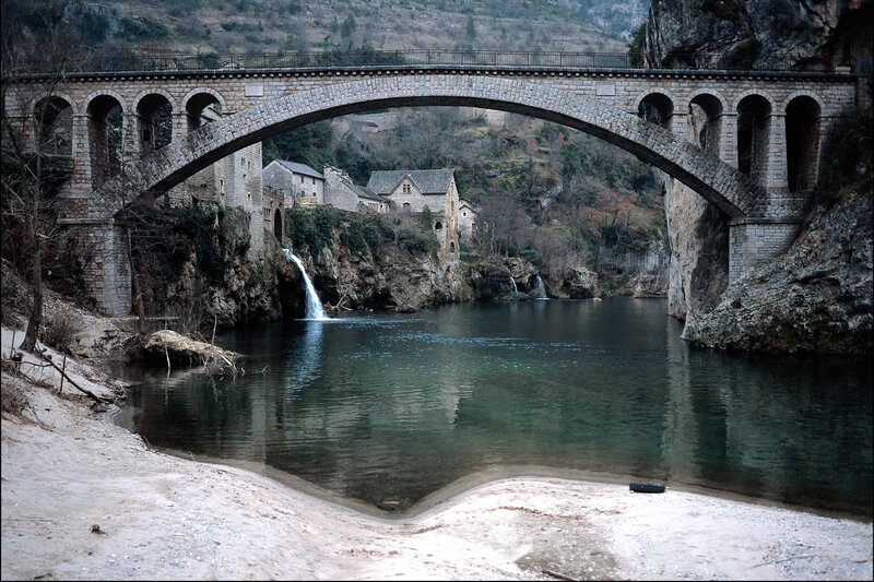 Stone Arch Bridge over River — Gray