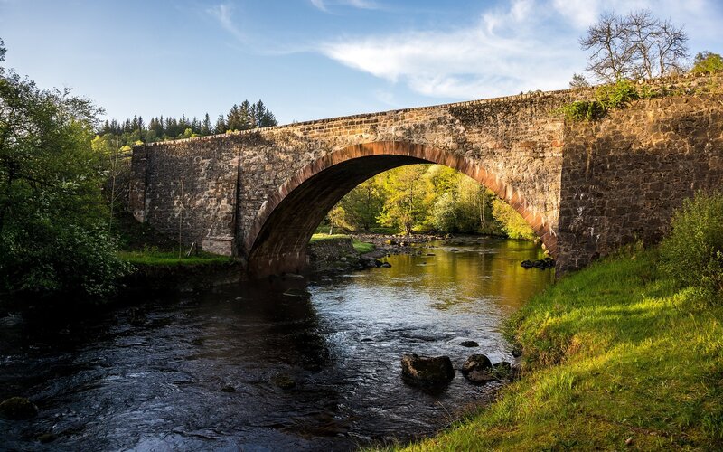 Stone Arch Bridge over River — Green, Serene, Afternoon