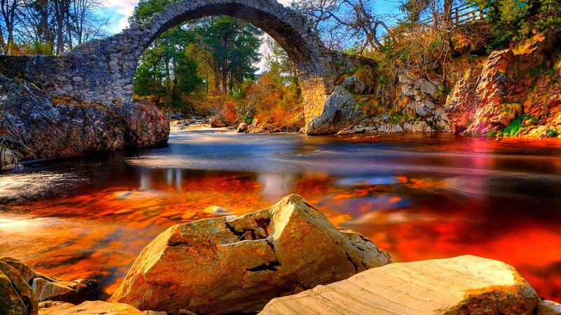 Stone Arch Bridge over River — Red