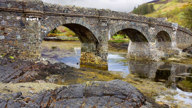 Stone arch bridge over river