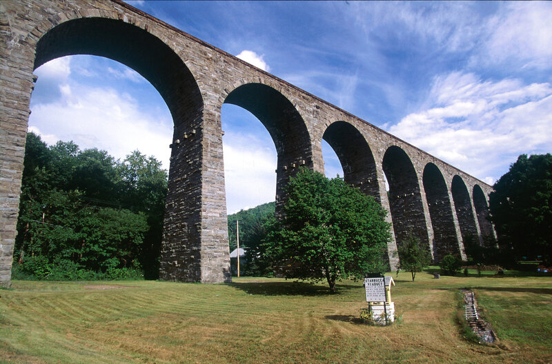 Stone arch viaduct in rural landscape