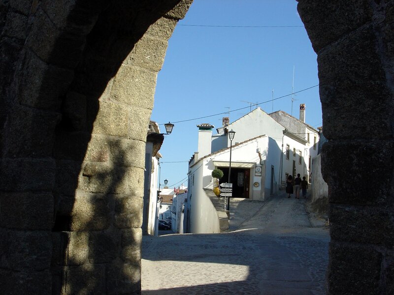 Stone archway view of a cobblestone street