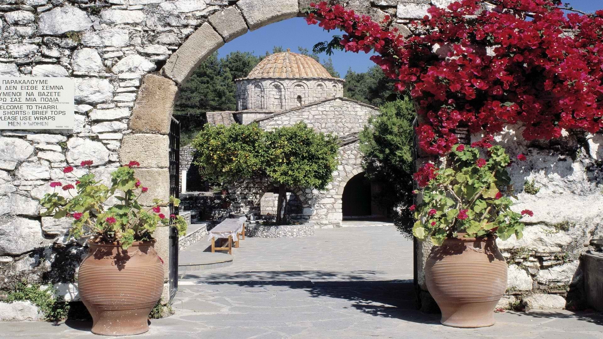 Stone archway with flowering plants
