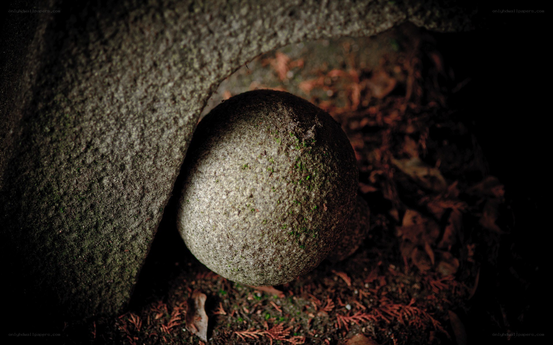stone ball in a stone arch