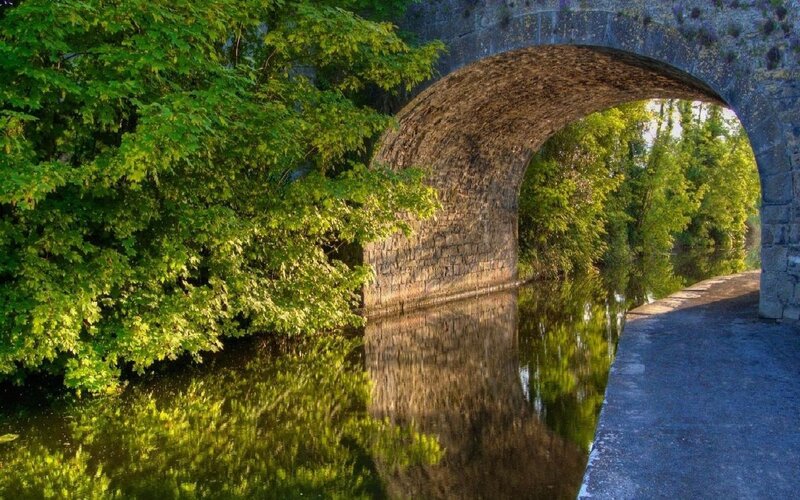 Stone bridge over a calm river