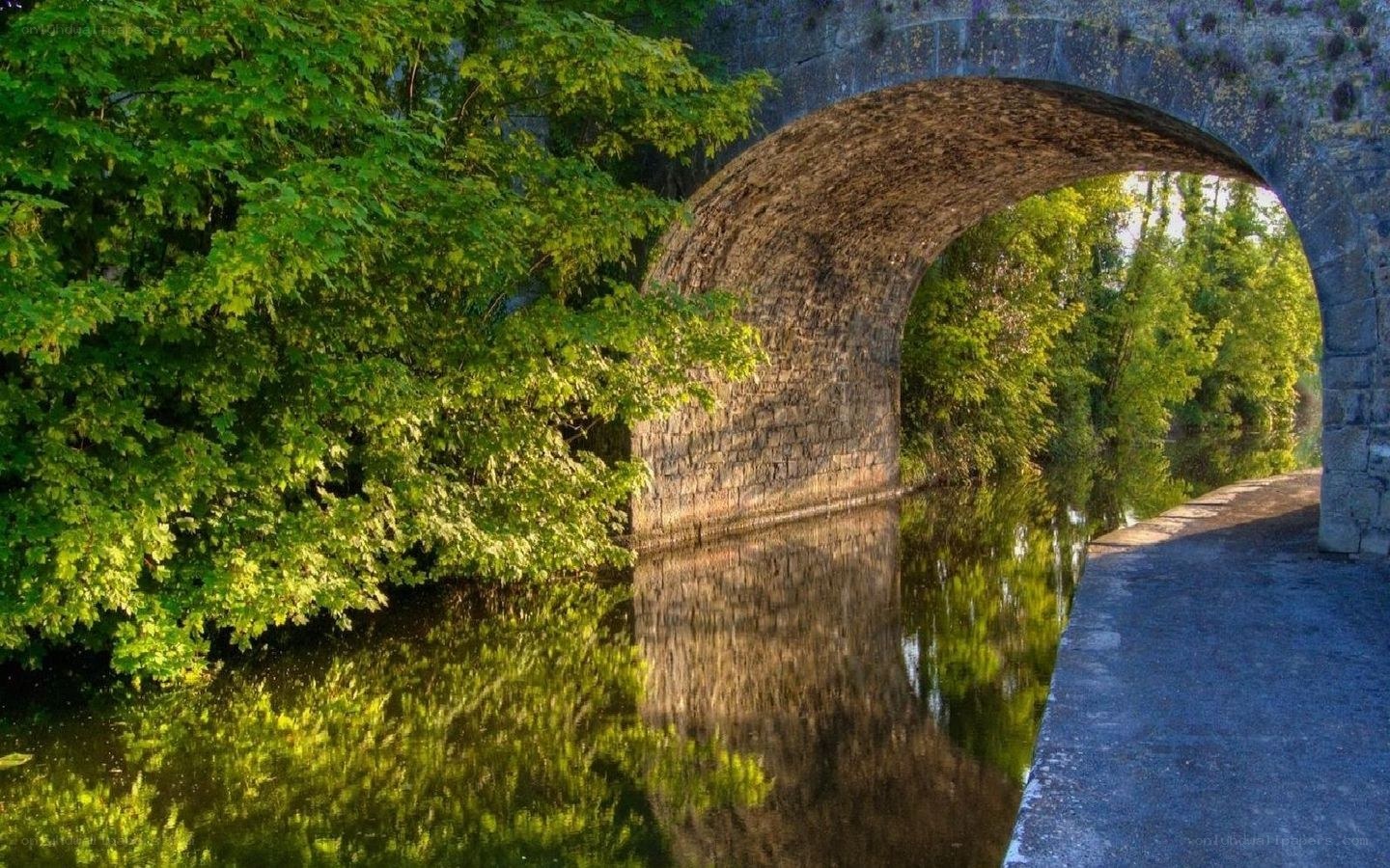 Stone bridge over a calm river