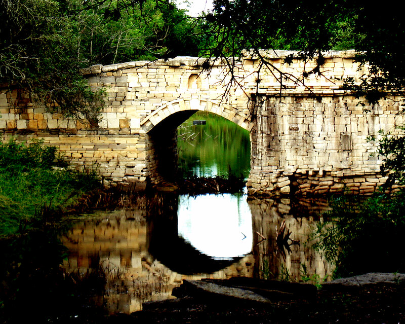 Stone bridge over a calm river