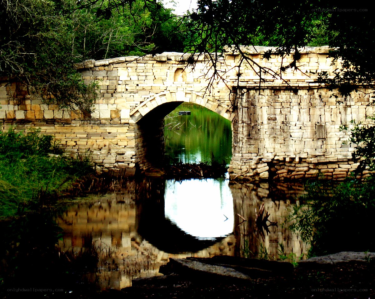 Stone bridge over a calm river