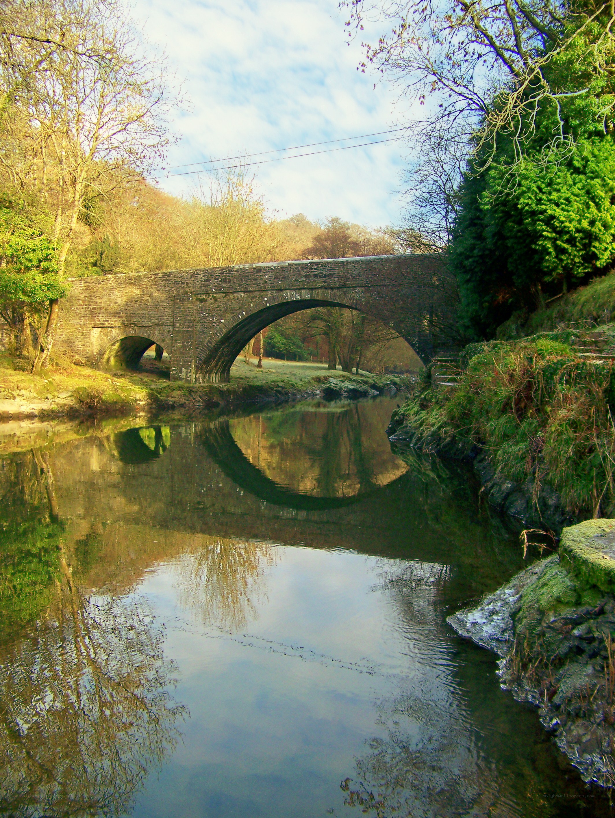 Stone bridge over a calm river