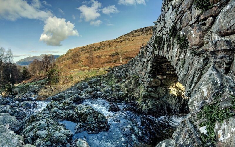 Stone bridge over a rocky stream