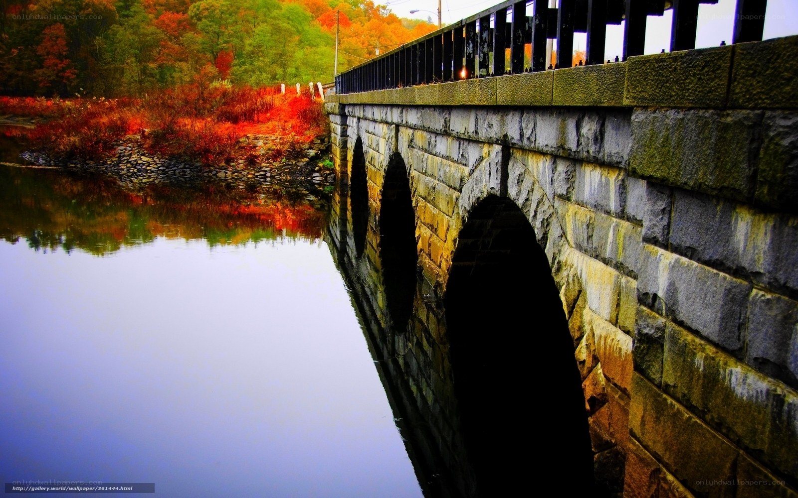 Stone bridge over autumn river
