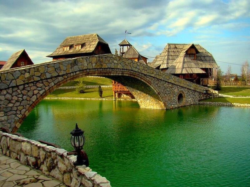 Stone bridge over green water