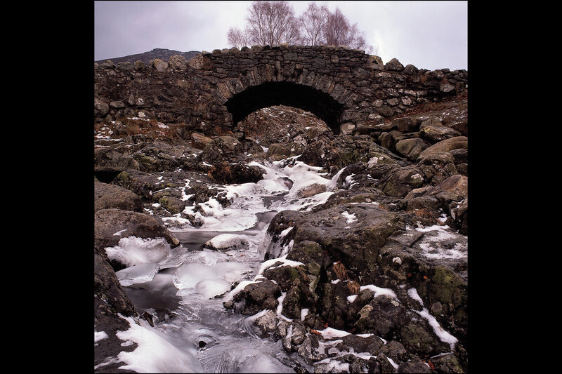 Stone bridge over icy stream