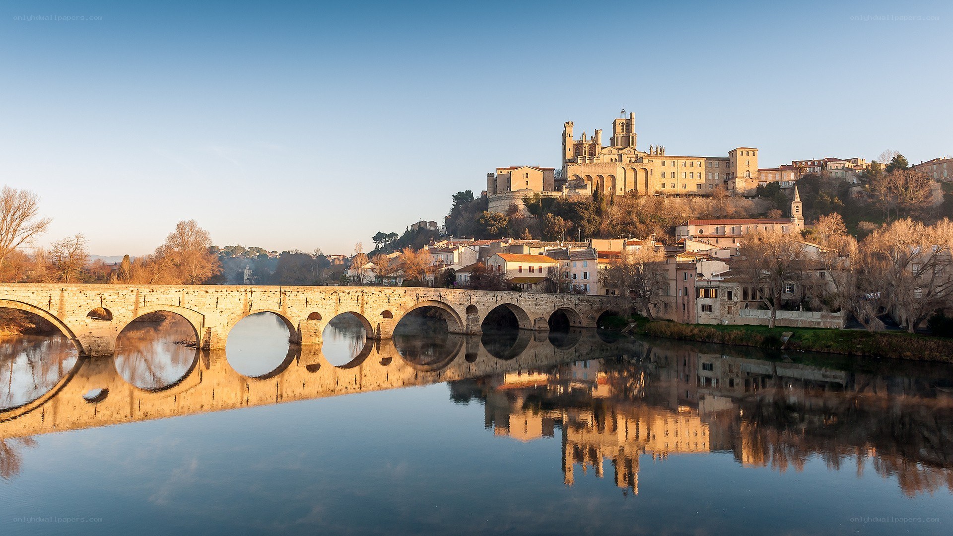 Stone bridge over river at dawn