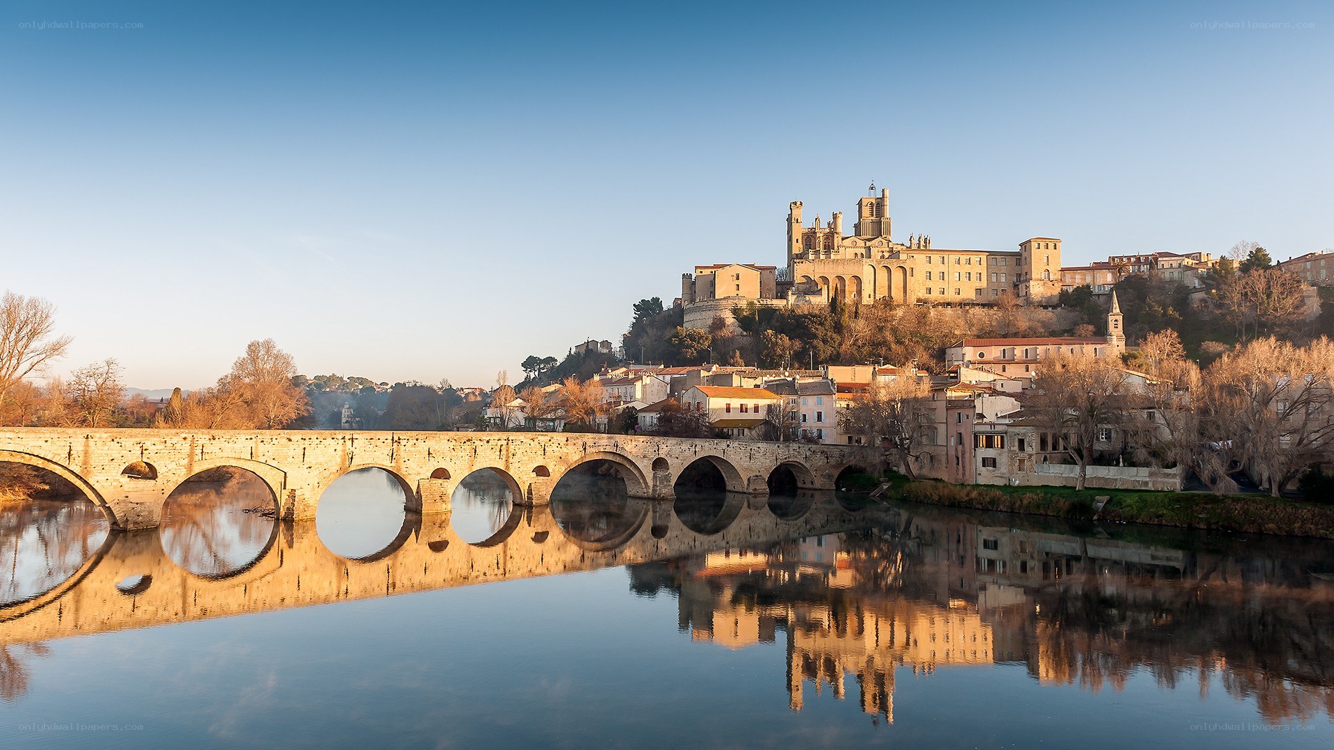 Stone bridge over river at dawn