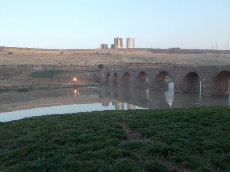 Stone bridge over river at dusk