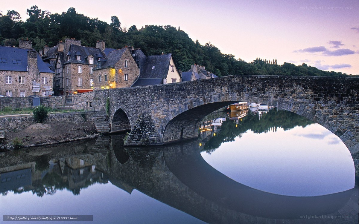 Stone bridge over river at dusk