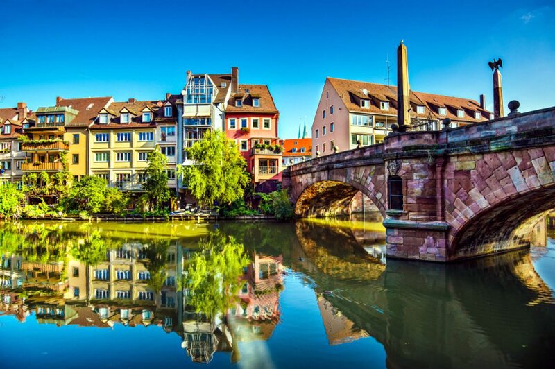 Stone Bridge over River — Blue, Serene, Afternoon, Photograph, Buildings, Trees, Sky