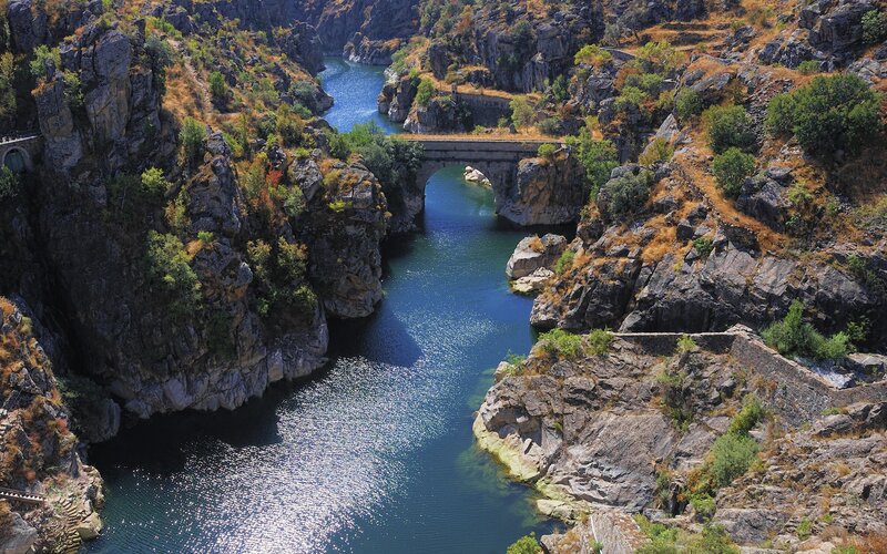 Stone Bridge over River — Blue, Serene, Afternoon, Photograph, Cliffs