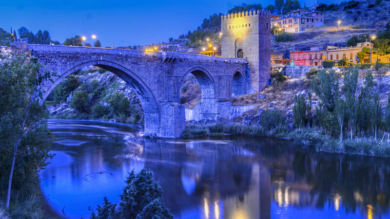 Stone Bridge over River — Blue, Serene, Night, Photograph, Tower