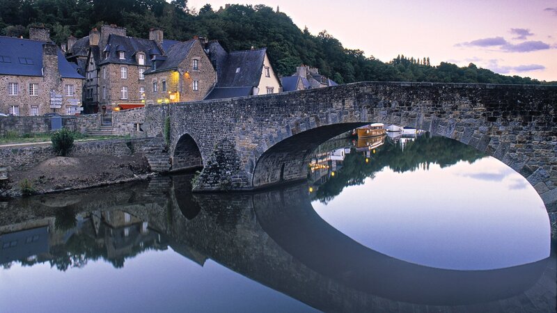Stone Bridge over River — Blue, Serene, Sunset, Photograph, Buildings, Trees, Boat