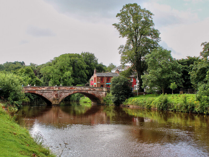 Stone Bridge over River — Green, Serene, Afternoon, Photograph, Trees, Buildings
