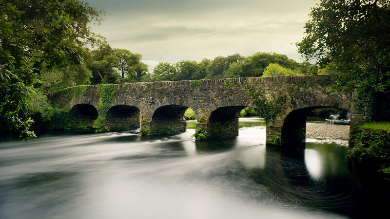Stone Bridge over River — Green, Serene, Afternoon, Photograph, Trees, Canoe, Gray
