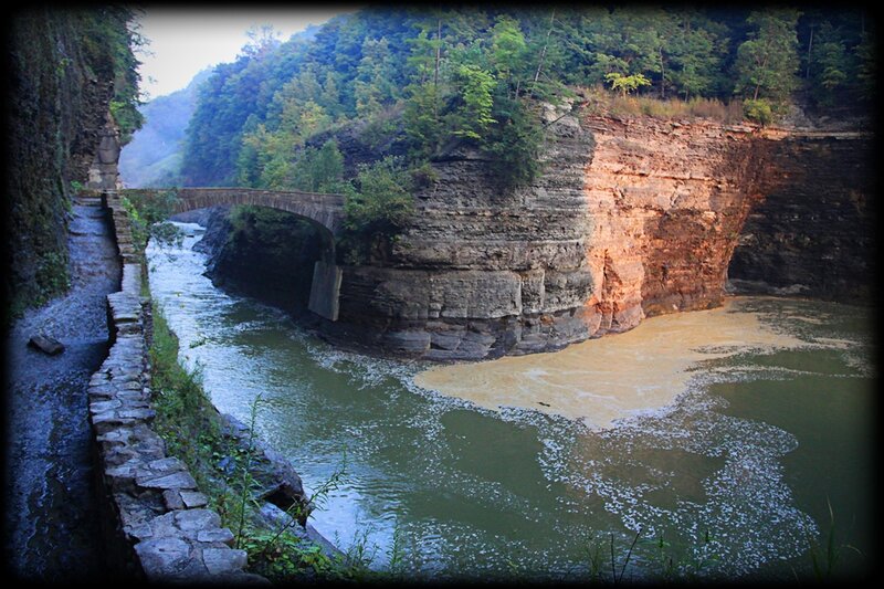 Stone bridge over river in canyon