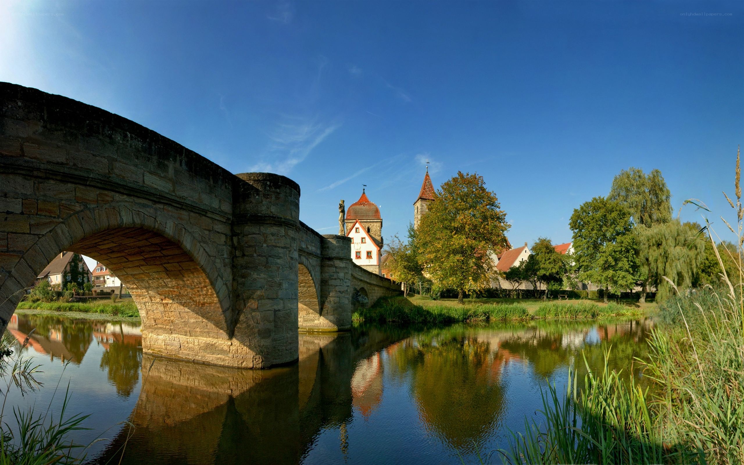Stone bridge over river in German town