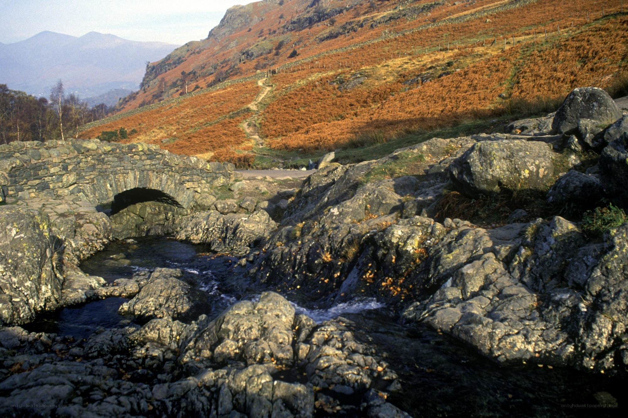 Stone bridge over river in hills