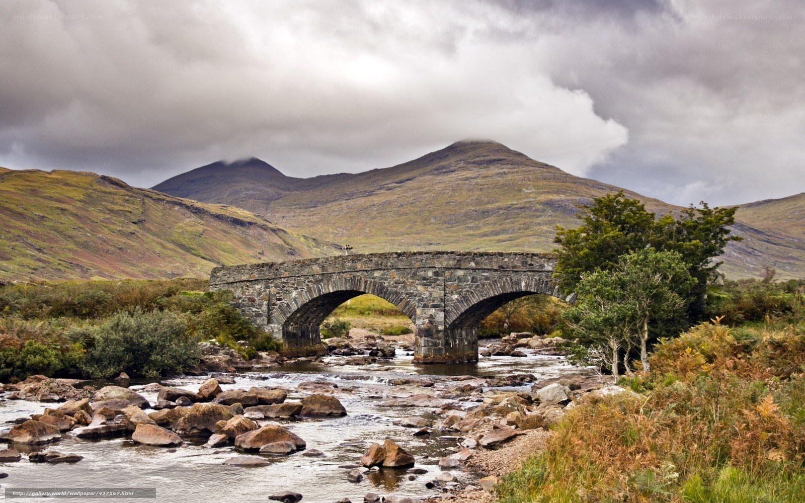 Stone bridge over river in mountains