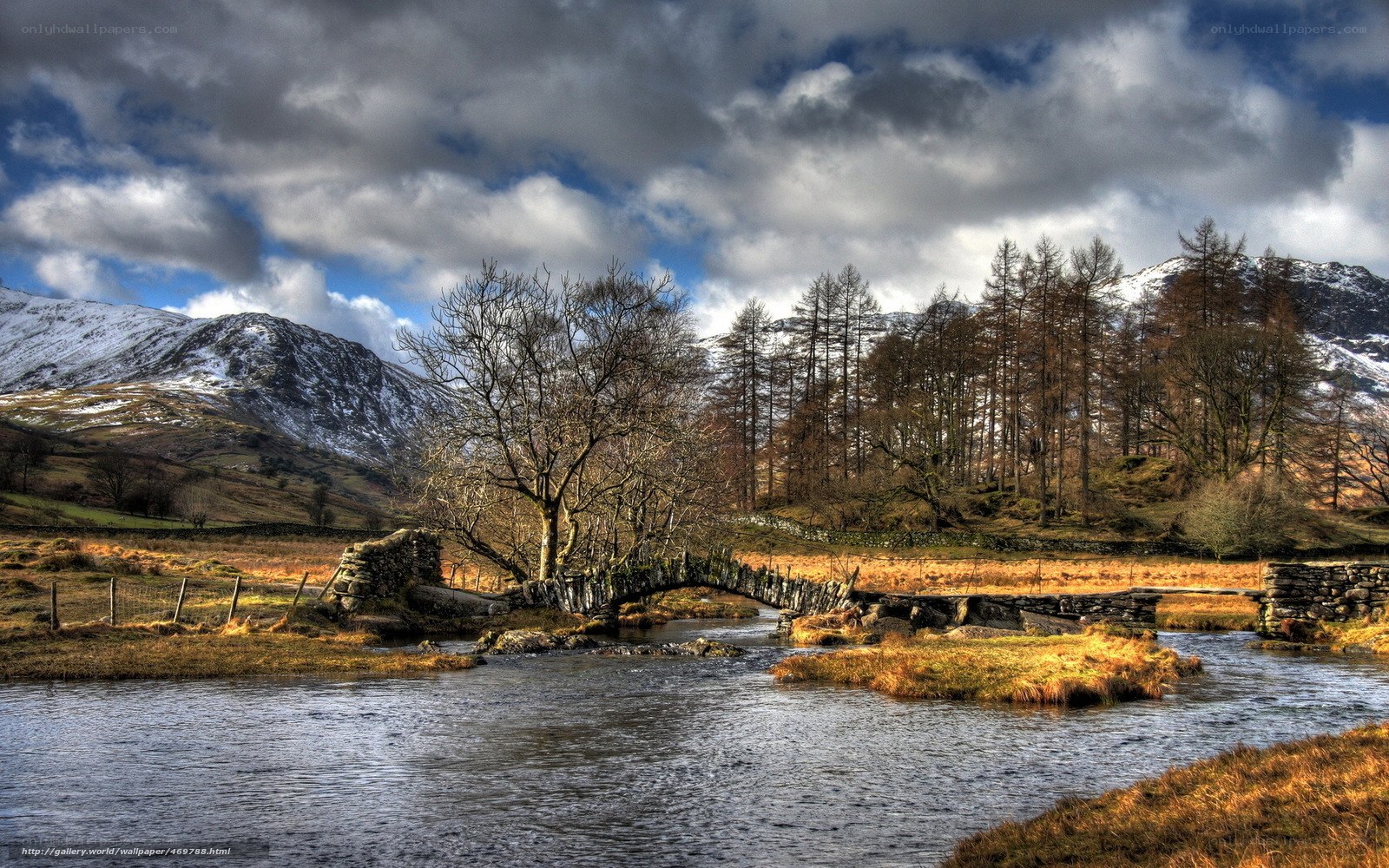 Stone bridge over river in mountains