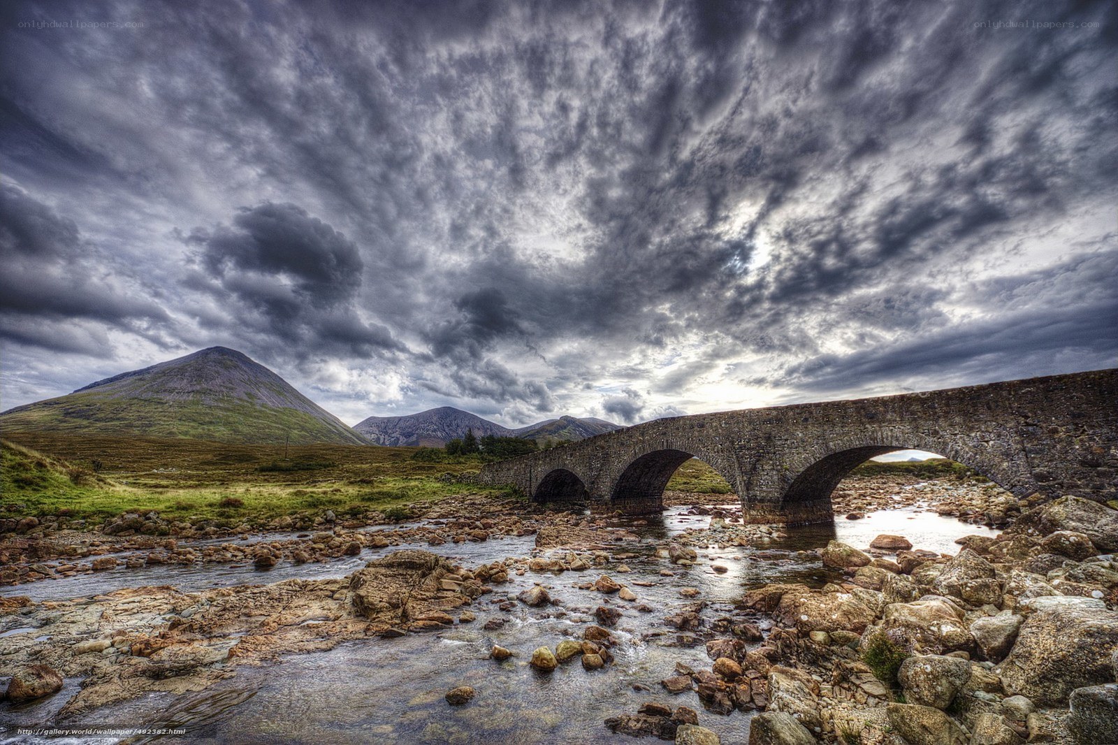 Stone bridge over river in mountains