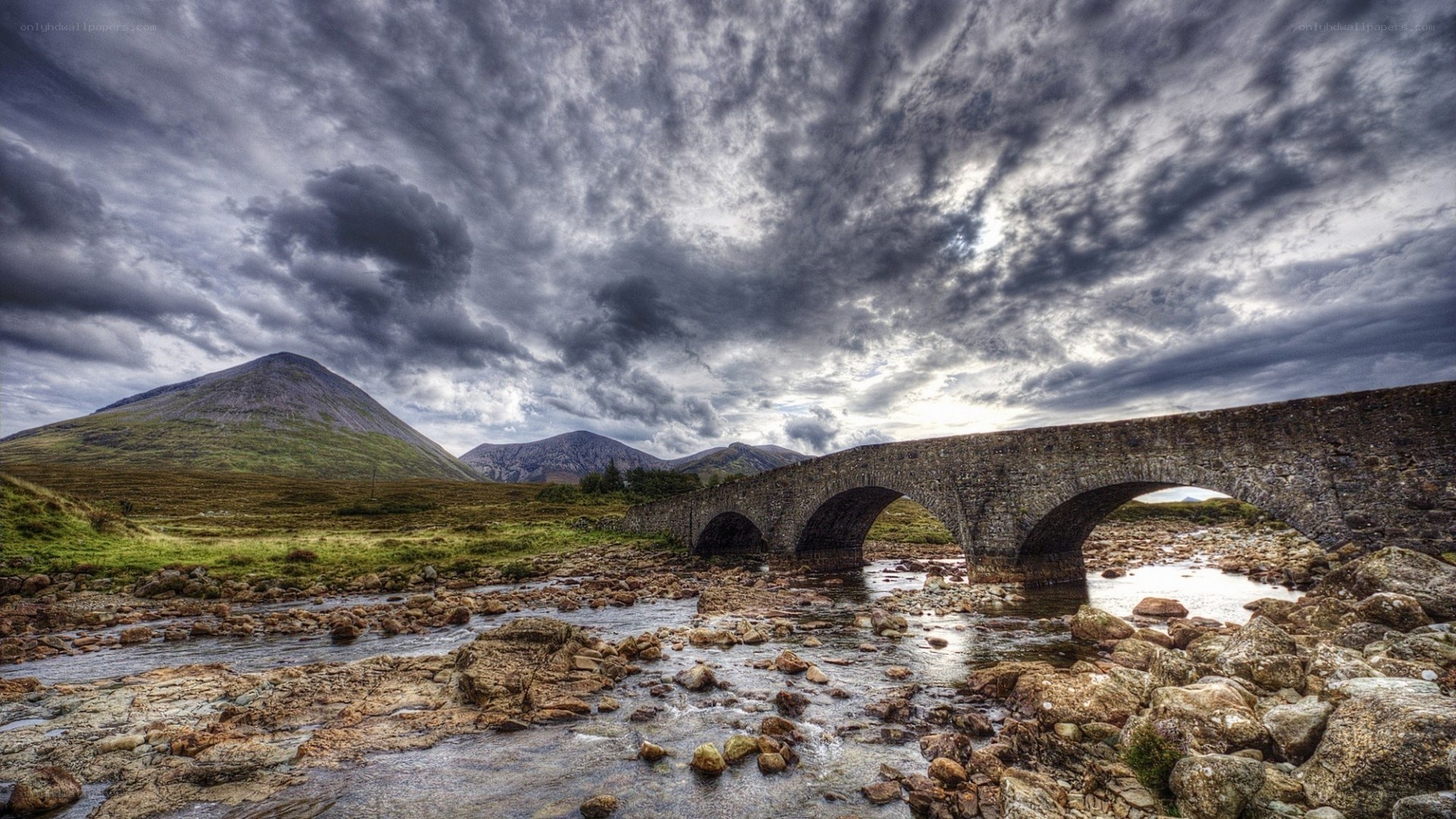 Stone bridge over river in mountains