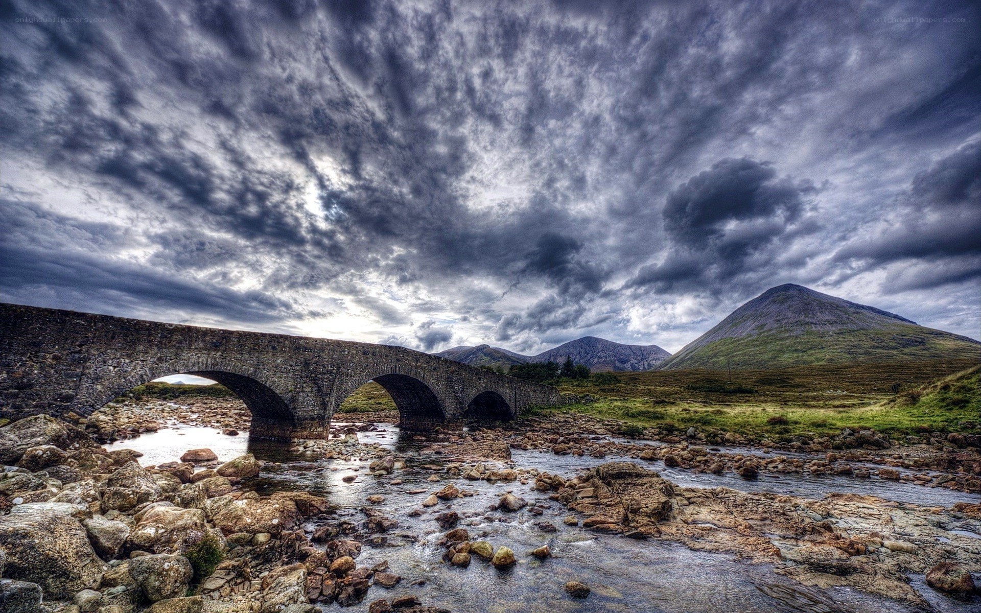 Stone bridge over river in mountains