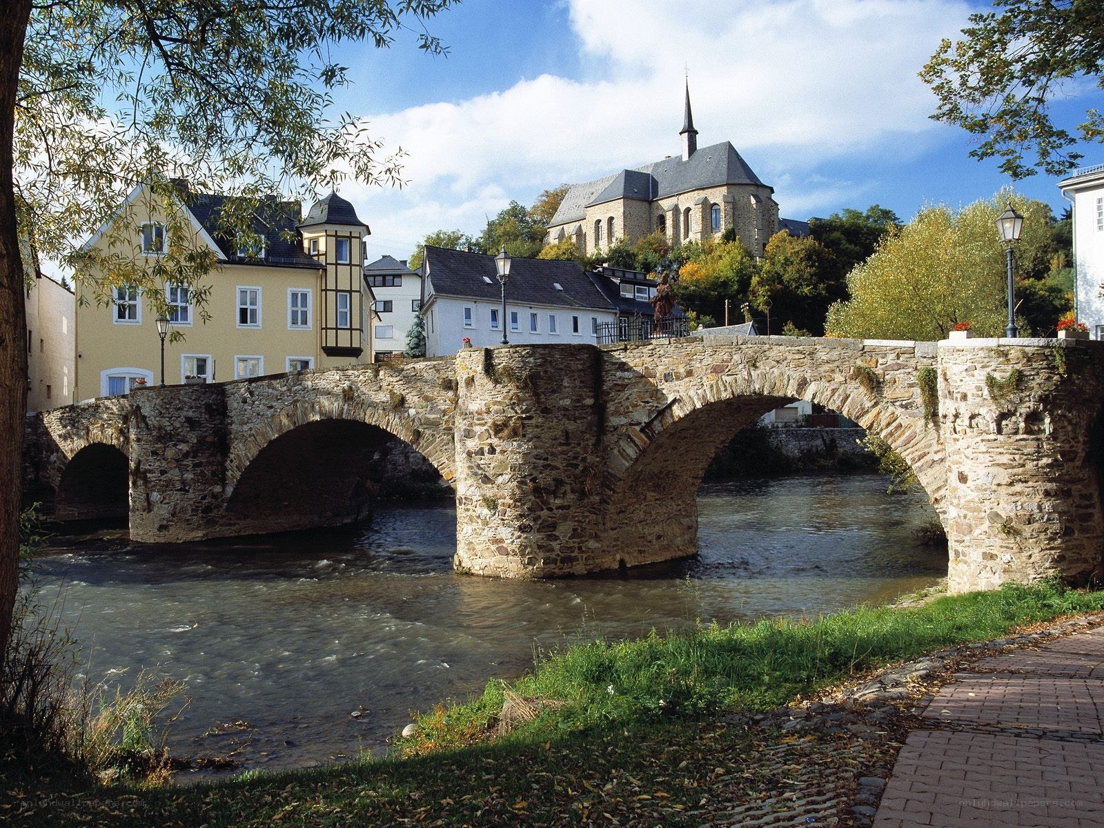 Stone bridge over river in town