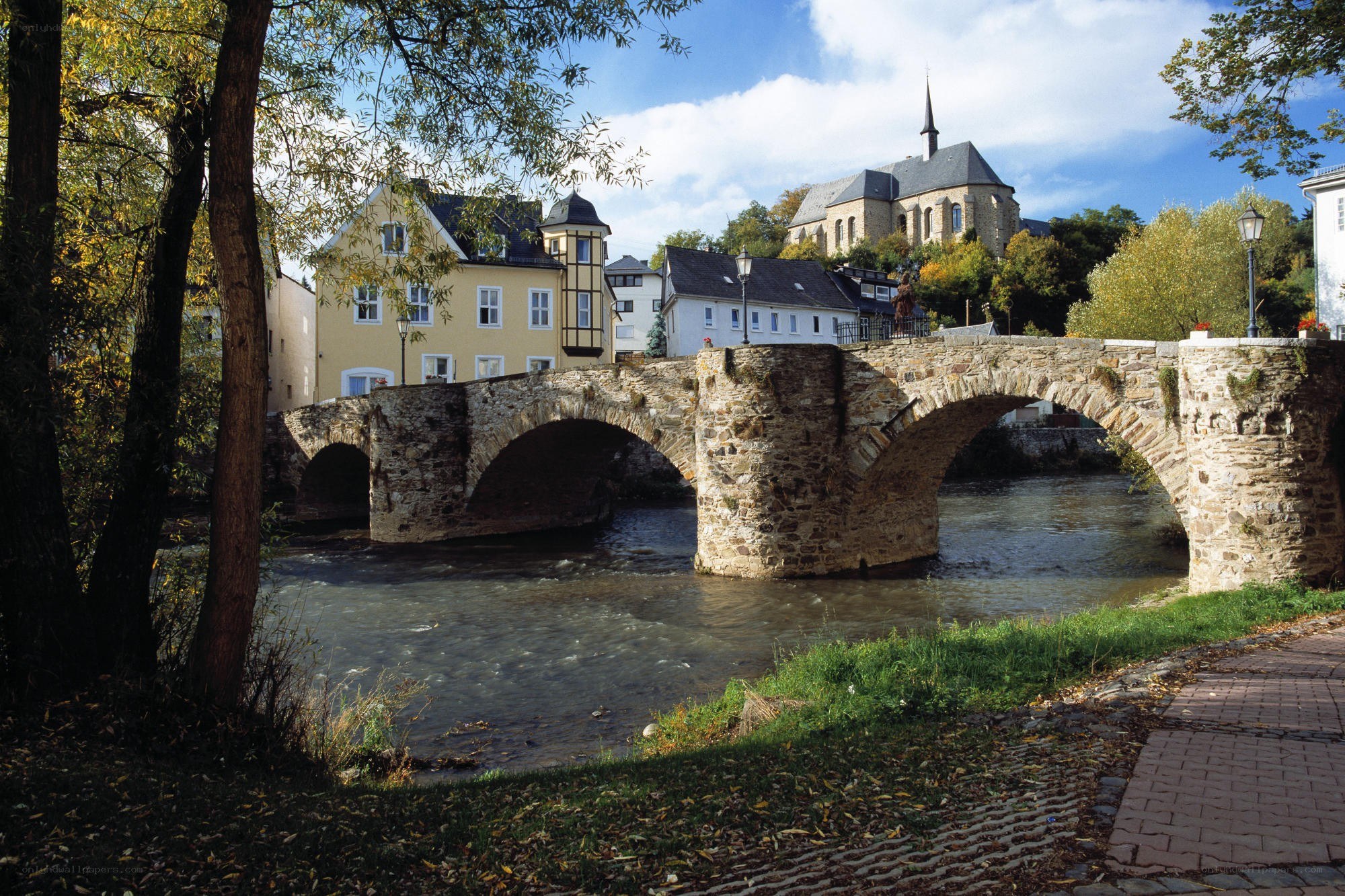 Stone bridge over river in town