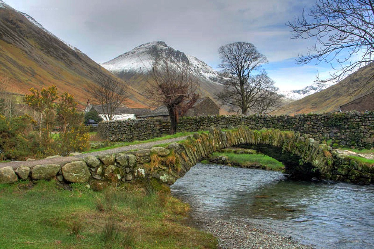 Stone bridge over river in valley