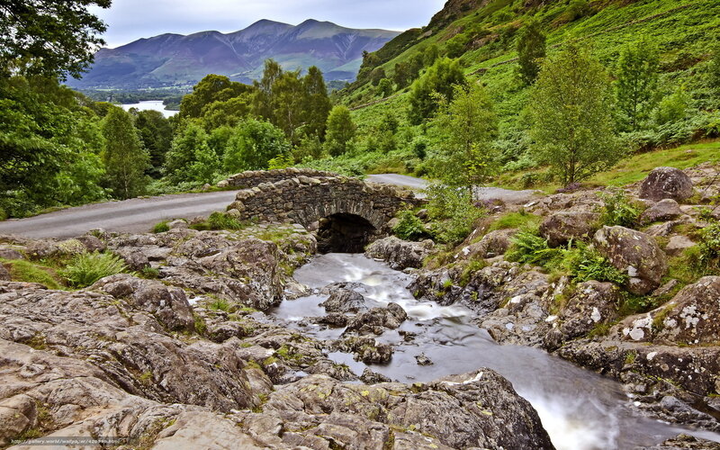 Stone bridge over river in valley