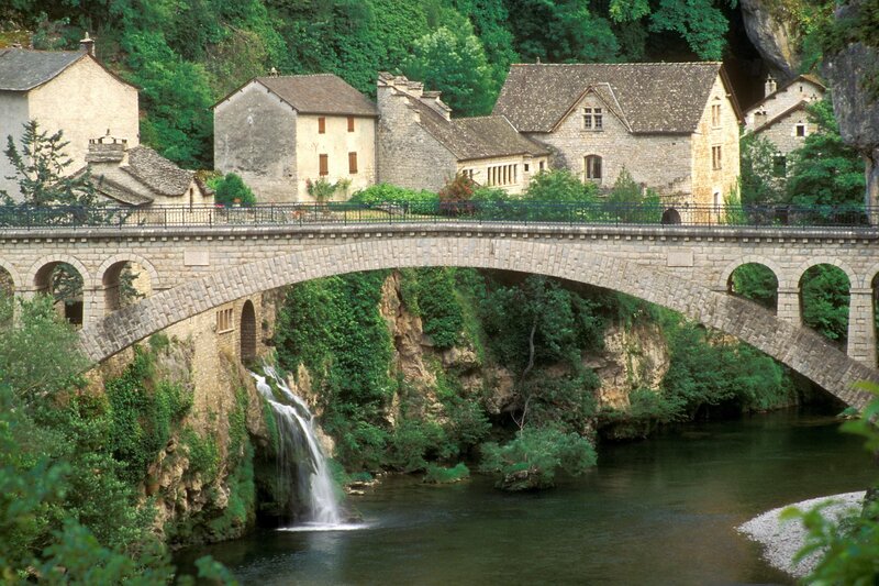 Stone bridge over river in village