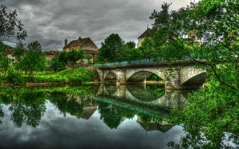 Stone bridge over river in village