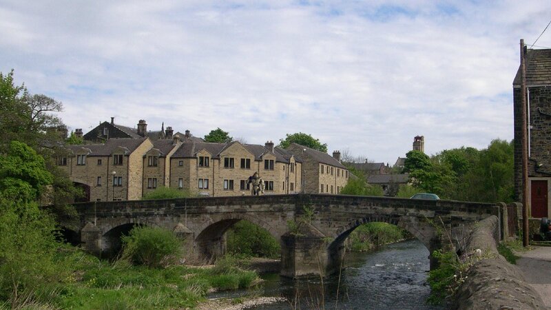 Stone bridge over river in village