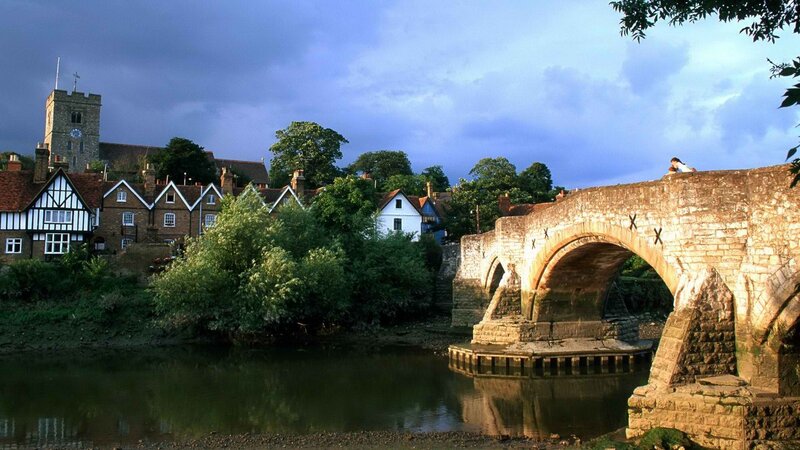 Stone bridge over river in village