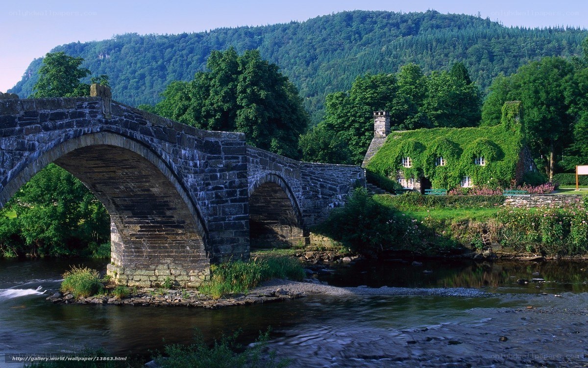 Stone bridge over river in village