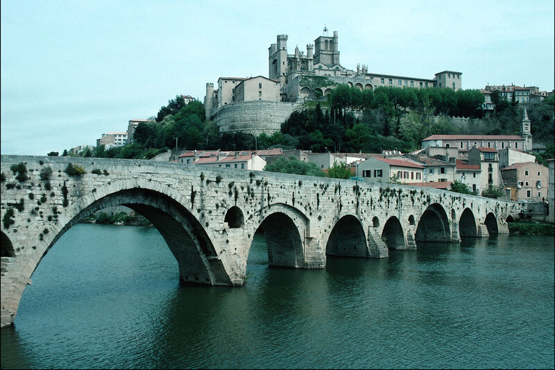 Stone bridge over river with cathedral