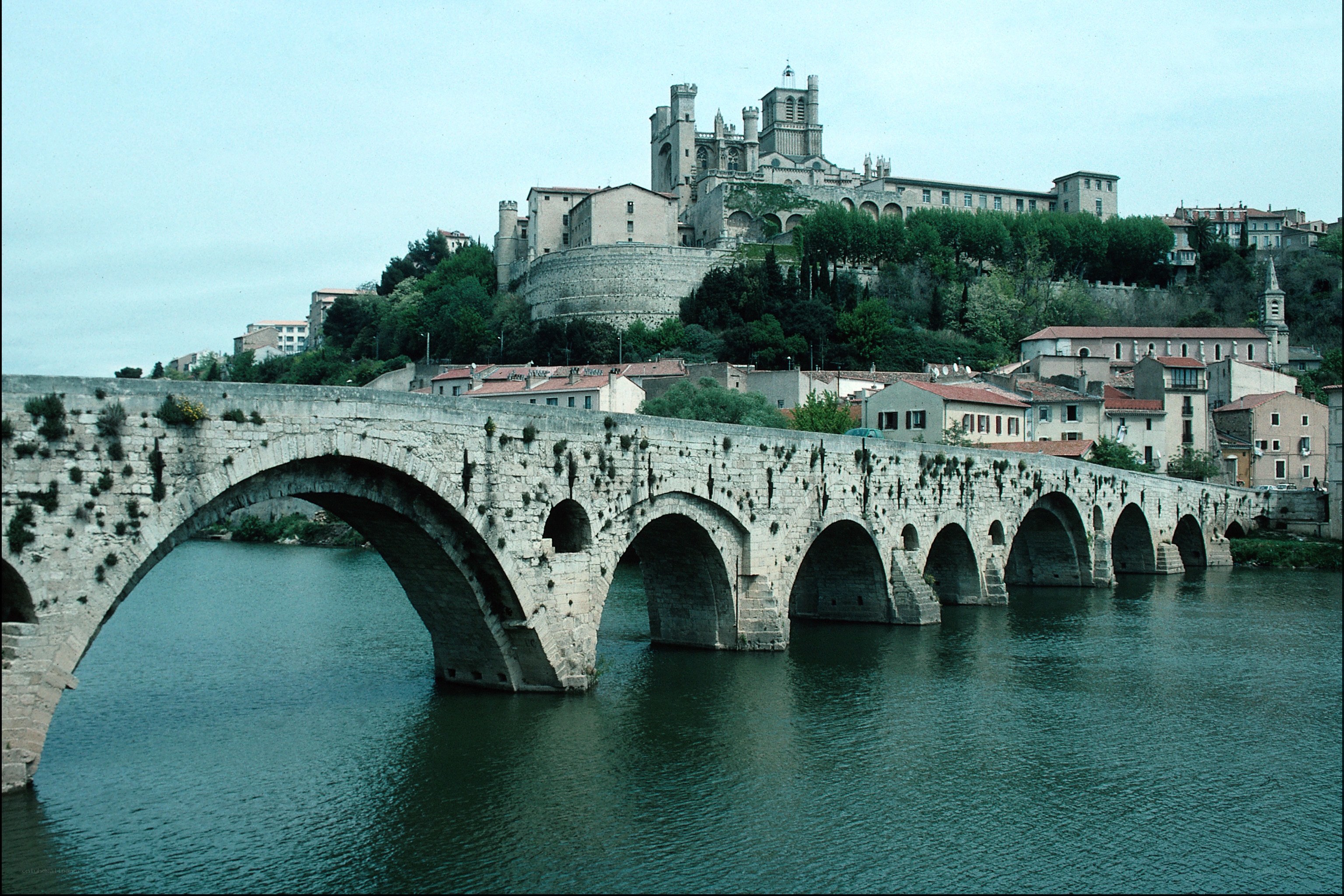 Stone bridge over river with cathedral