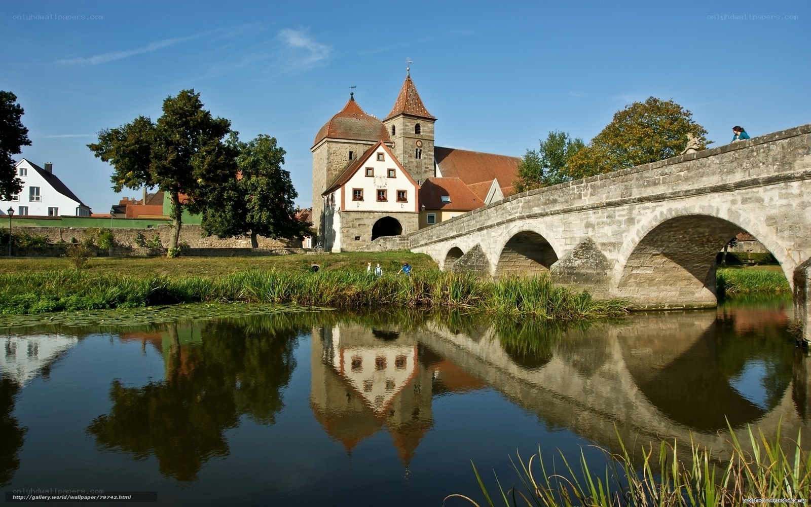 Stone bridge over river with church